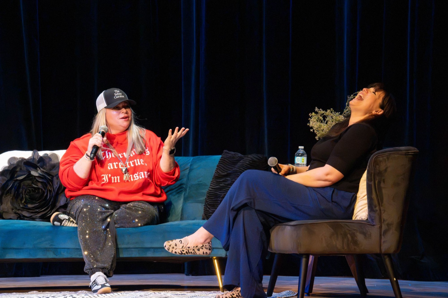 Brooke laughing out loud on stage during a live conversation